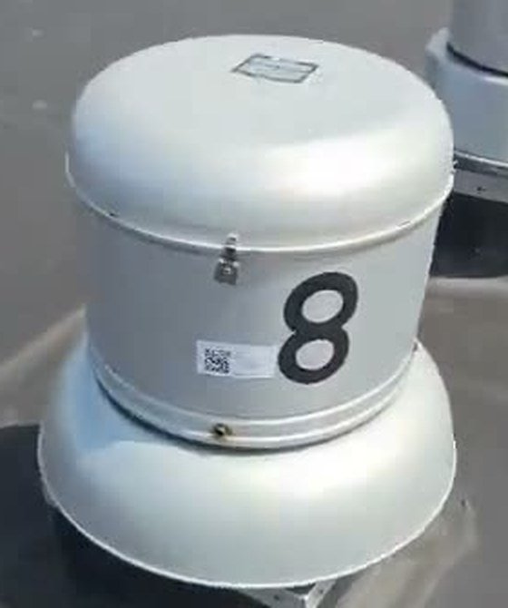 A QR label stuck on a rooftop exhaust fan